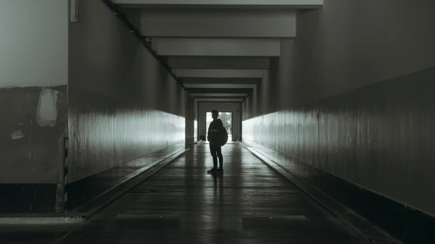 a person walking down a hallway between two floors