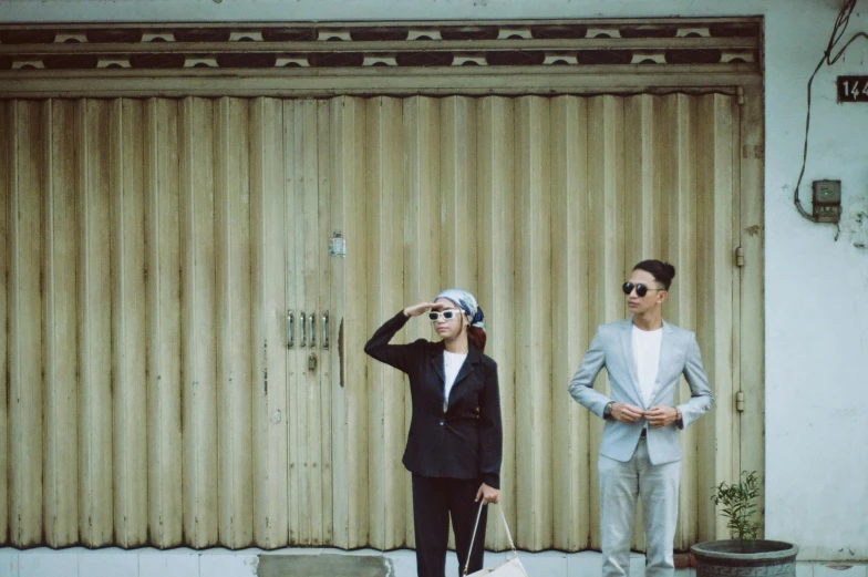 a man and woman in business attire are holding bags