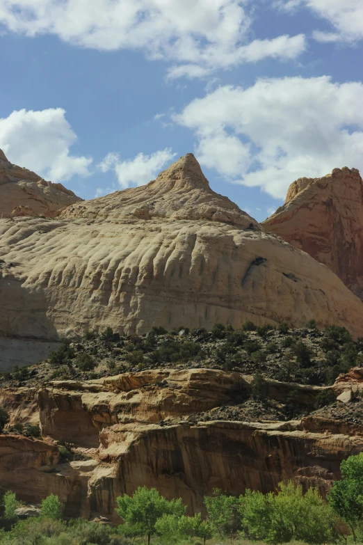 the mountains that surround a small river are covered in rock