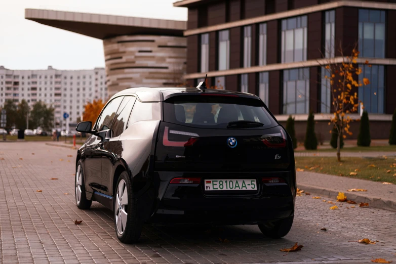 an electric vehicle with an open door parked on a street