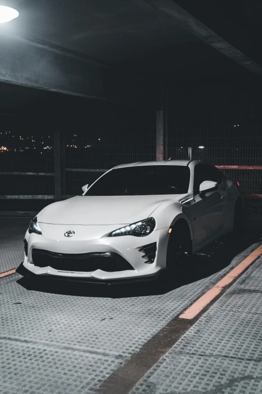 a white car parked in an underground area