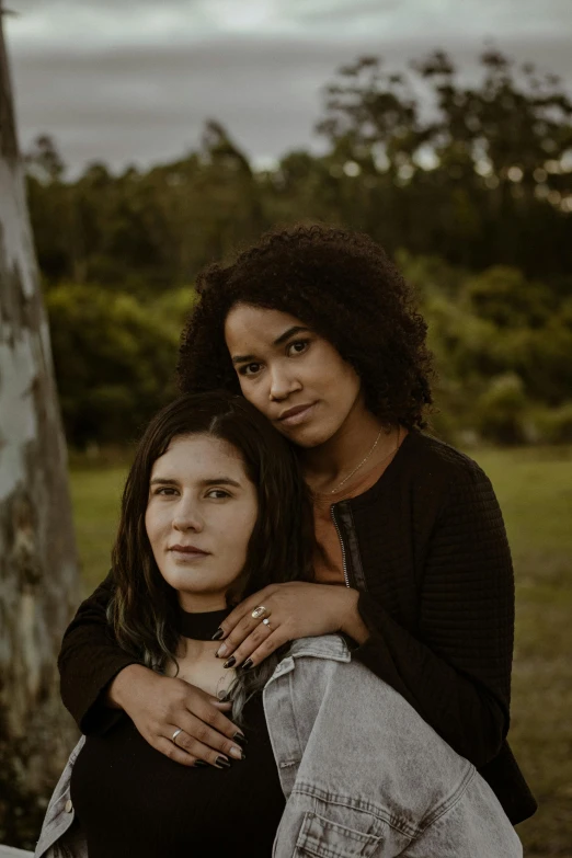 two women, one is emcing the other's neck