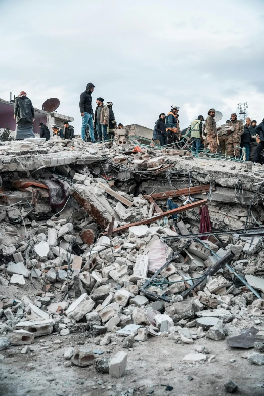 the people are standing around in rubble together