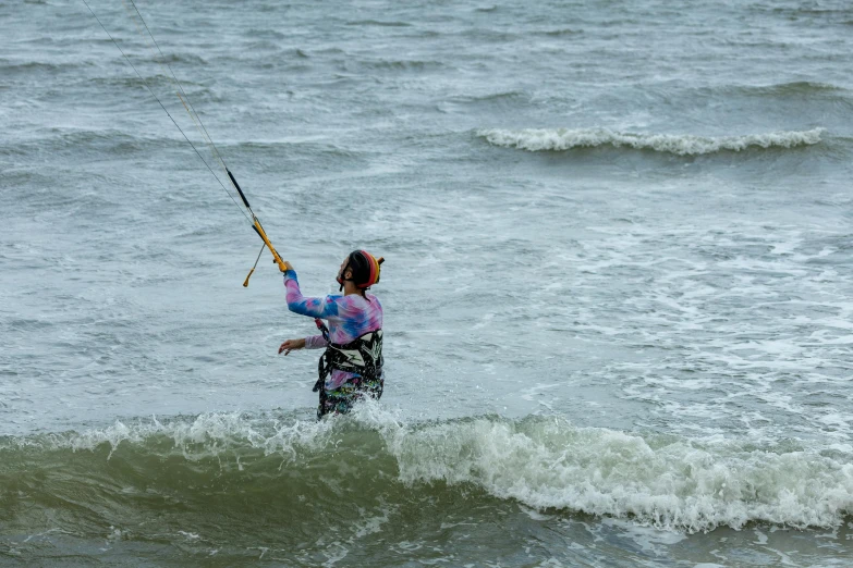 a person holding a rope and a pole in the ocean