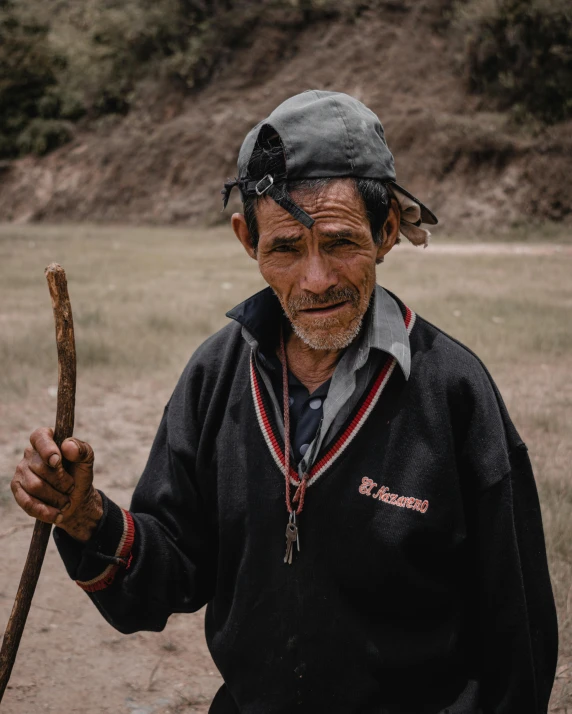 the older man has a stick that holds soing in his hands