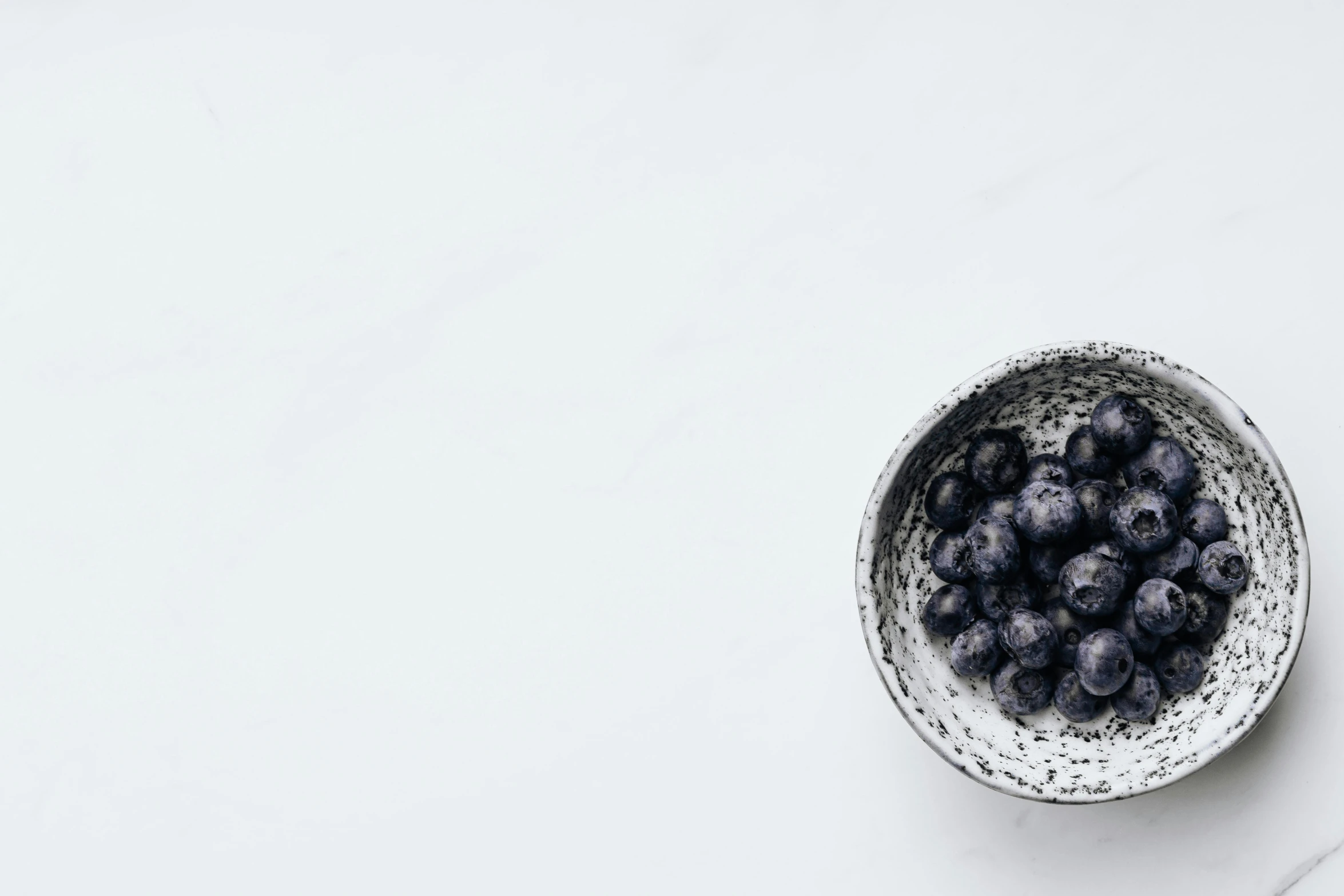 a bowl with fresh berries in it and next to it