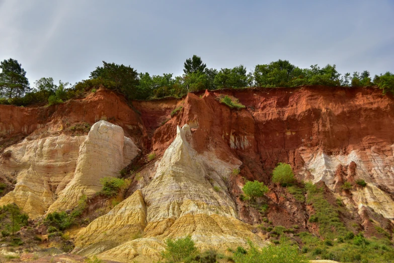 some very pretty colored cliffs with trees on the sides