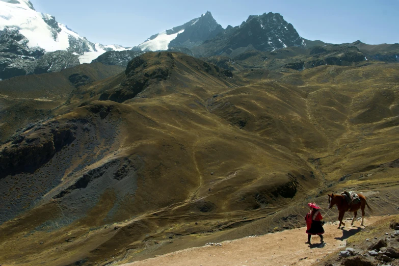 two people that are standing on a trail