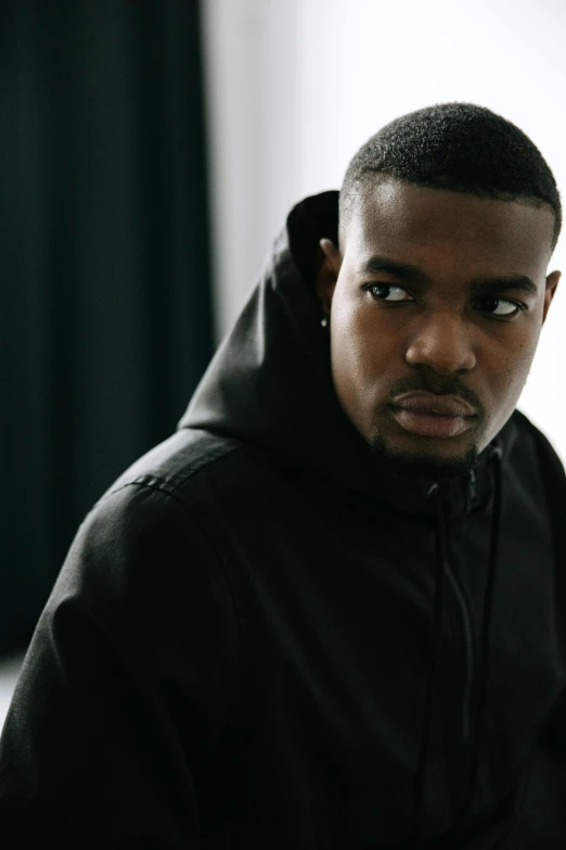 a man in a hoodie looking at the camera