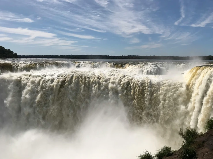 the water is rushing out the edge of the dam