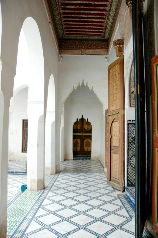 a room with an intricate tiled floor and doorways