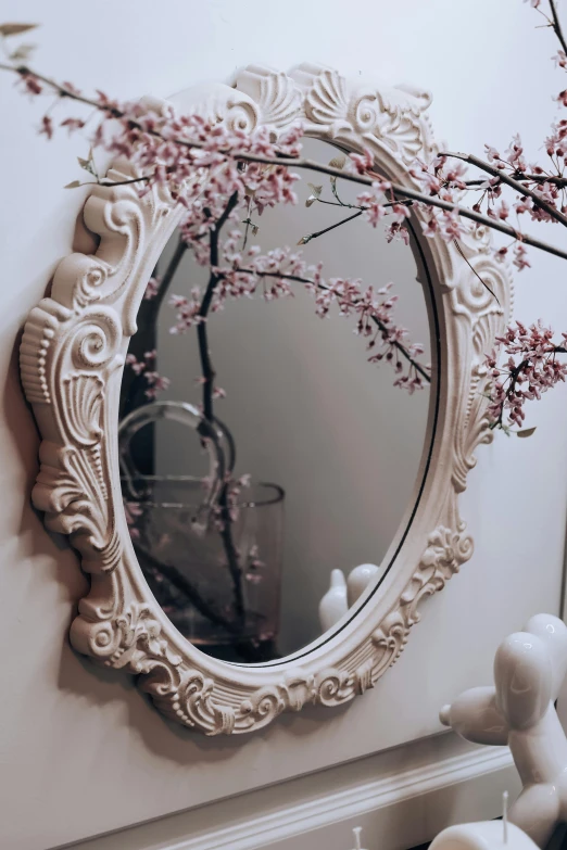 a mirror with red flowers hanging from it