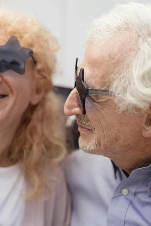 an older man and woman wearing fake batman masks