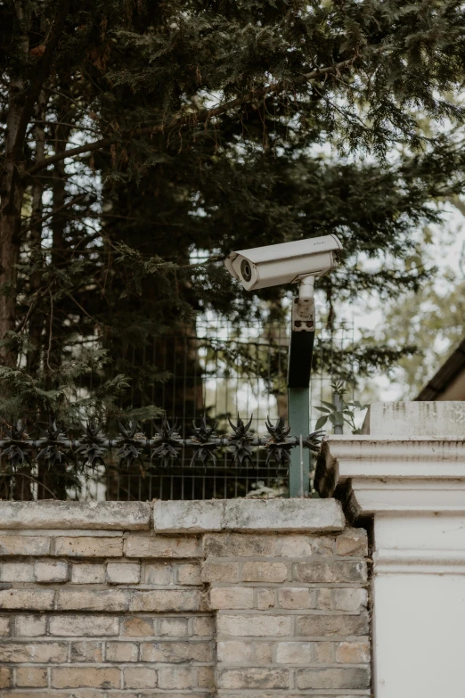 an overhead security camera on a brick wall