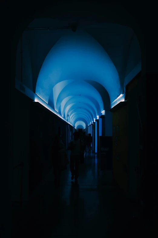 a hallway has lights at the end that give people control over what appears to be blue