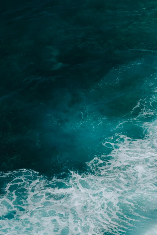 an aerial view of a surfer in the water