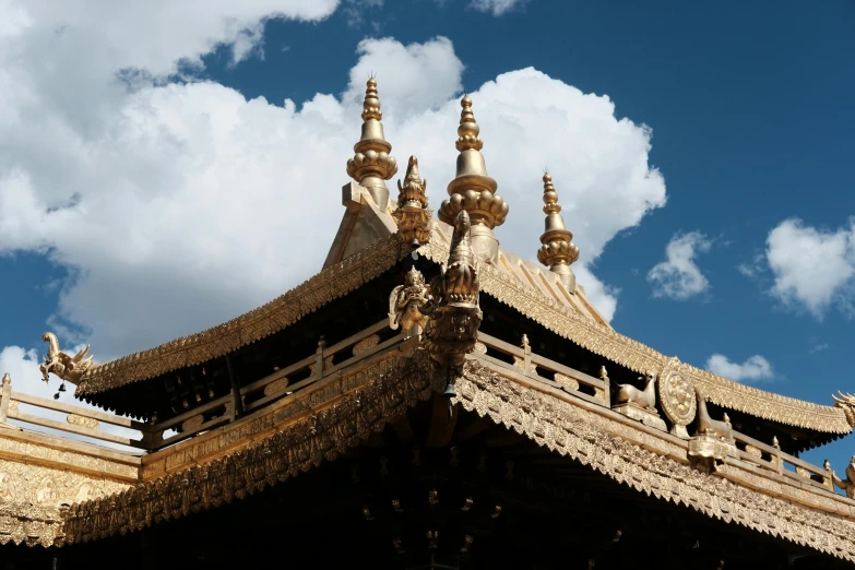 the top of an elaborate building with a sky background