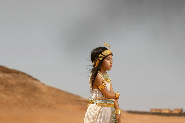 a beautiful  in a white dress with golden necklace and headdress on