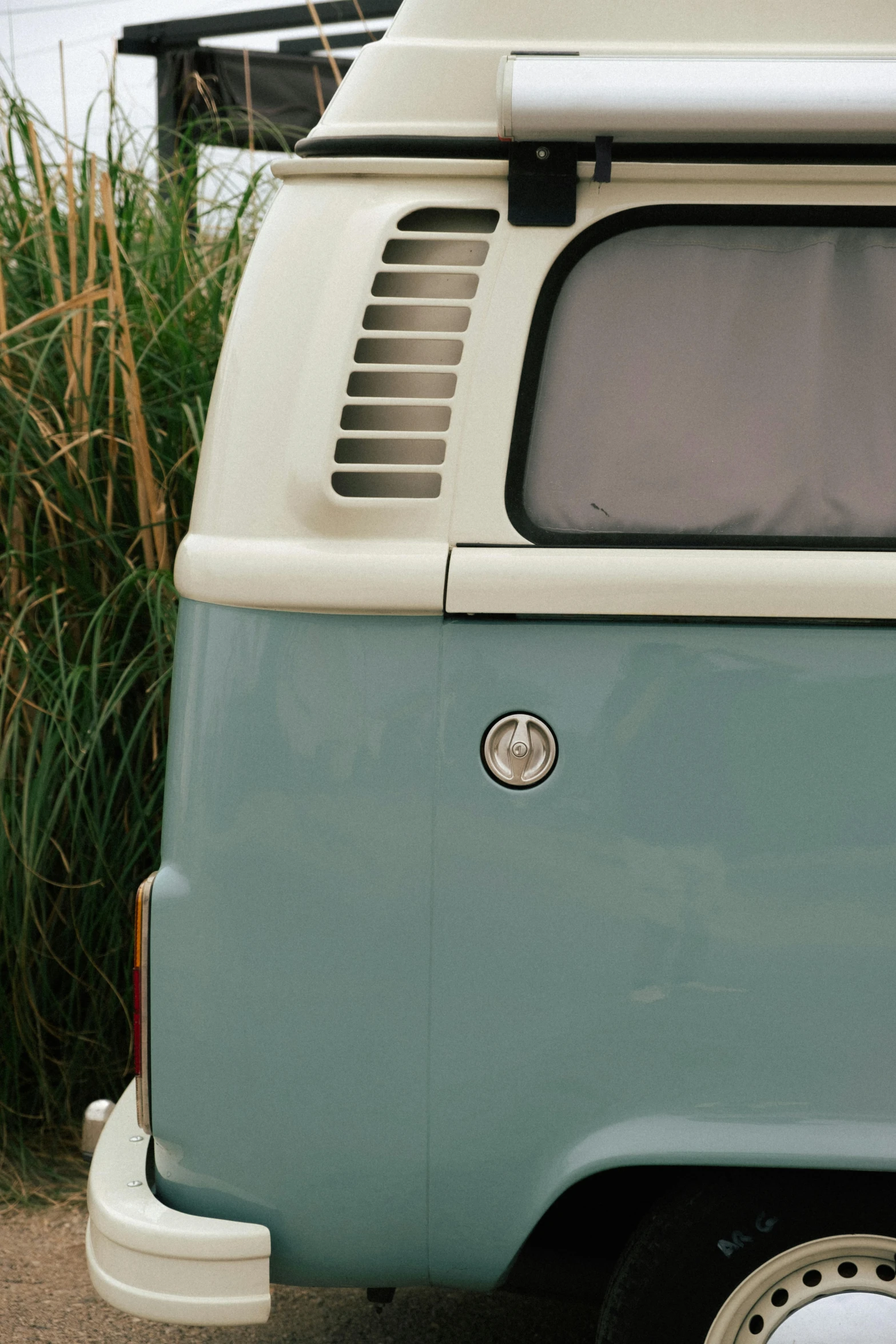 an old blue and white van parked on a street