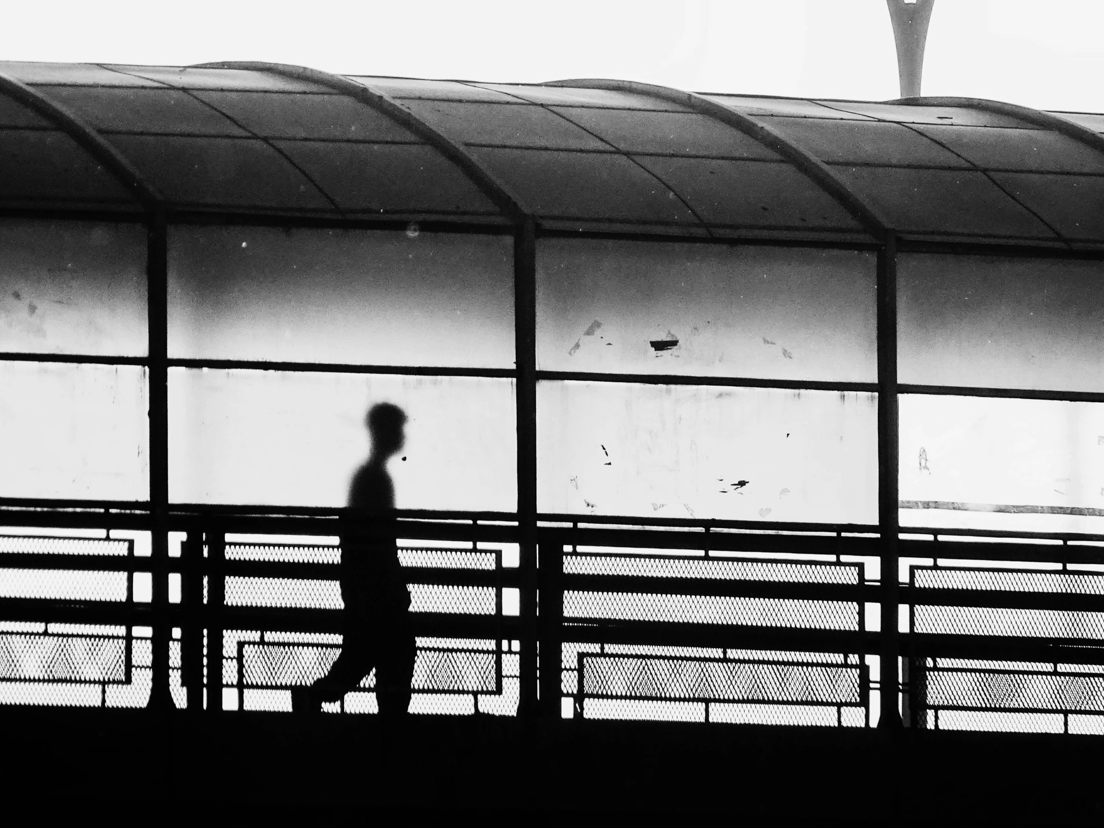 a person walking across a bridge in the dark