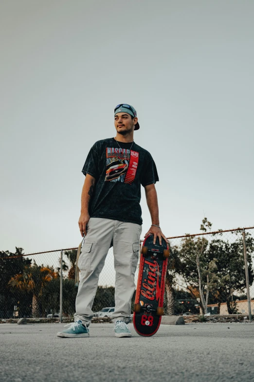 a man holds a skate board in front of his face