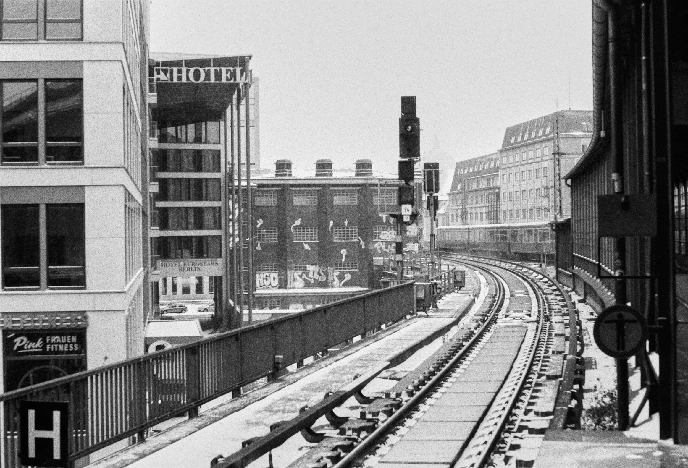 a black and white po of train tracks in the snow