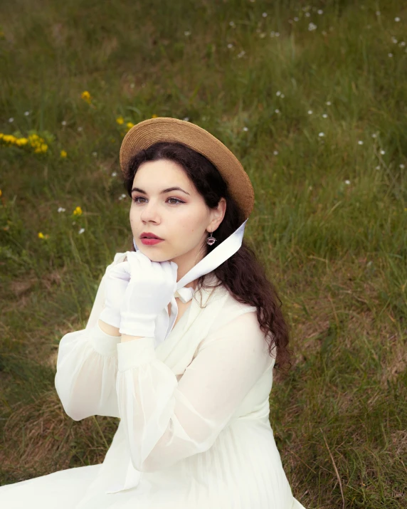 an old fashioned woman in white in a field with yellow flowers