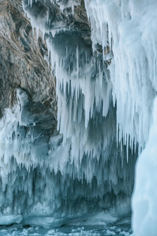 ice formations and icicles create patterns on the surface of a frozen mountain