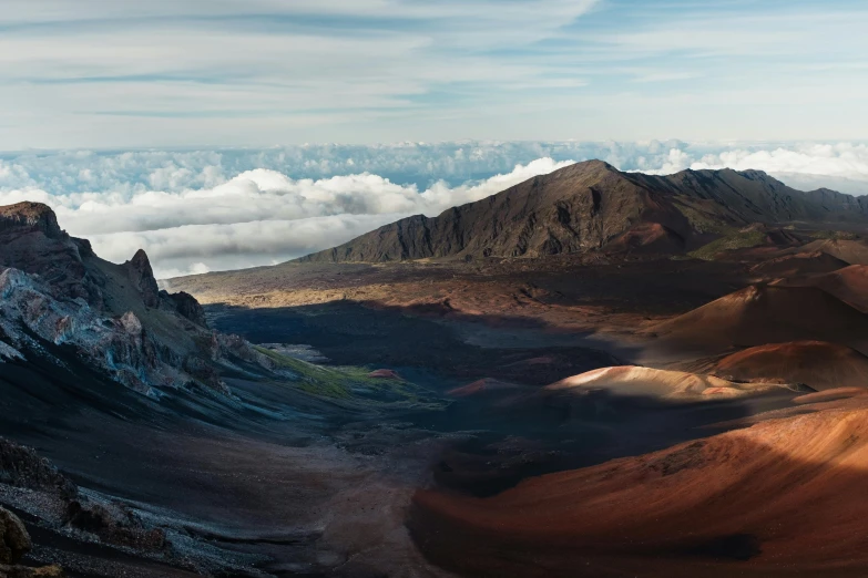 the mountains are covered in patches of dirt