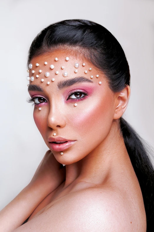a young woman with various small, round dots on her face