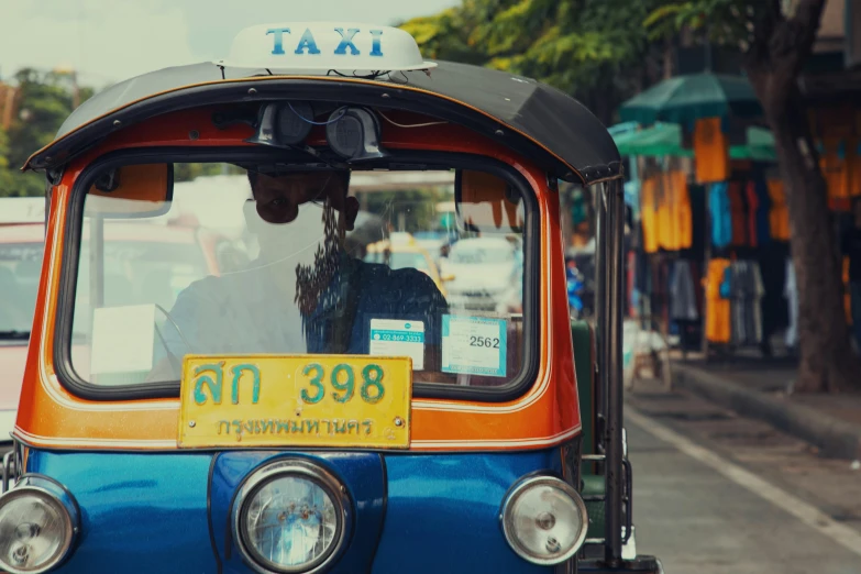 an old blue taxi cab on the street with its taxi license plate