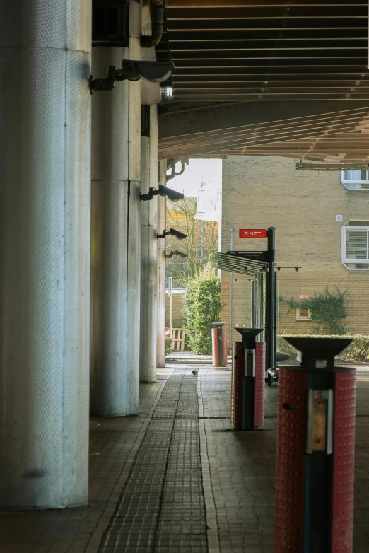 a walkway with several pillars and columns