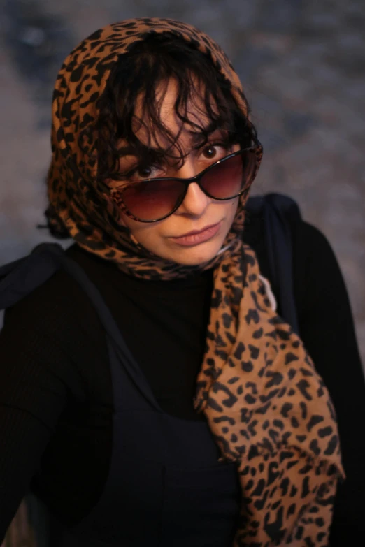 the woman in sunglasses has a leopard print scarf