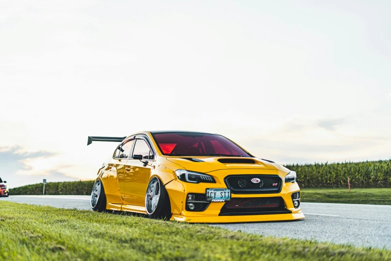 a yellow car parked on the side of a road