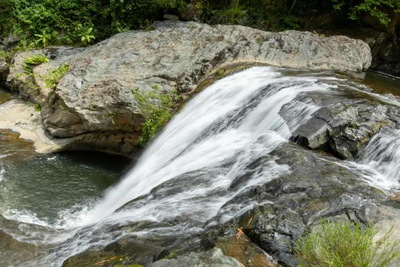 water flowing over the rock formation near the river