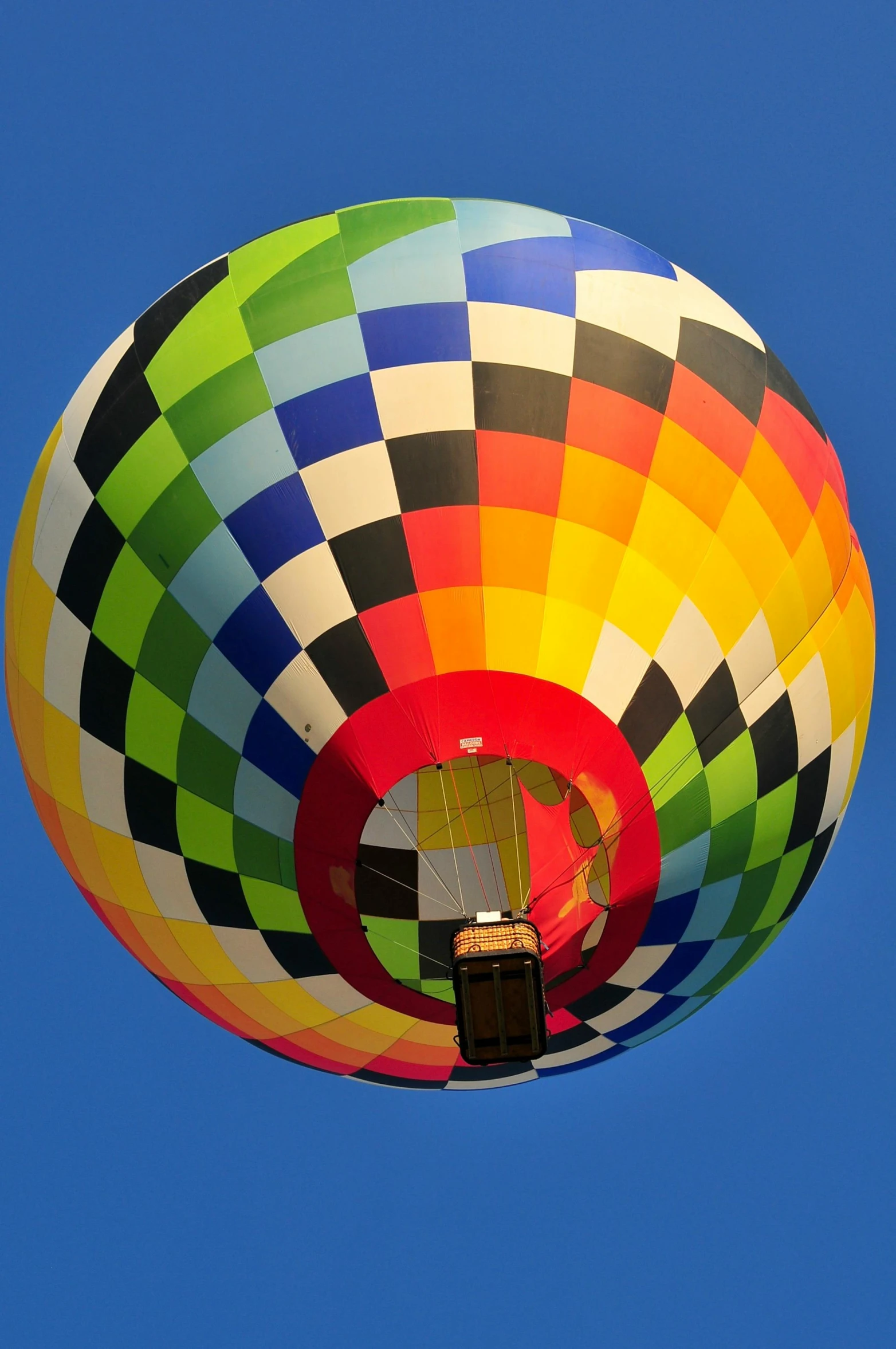 there is a large multi colored balloon that has a sky background