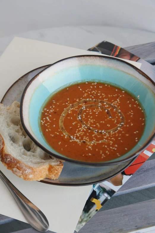 a bowl of food on a table next to a spoon