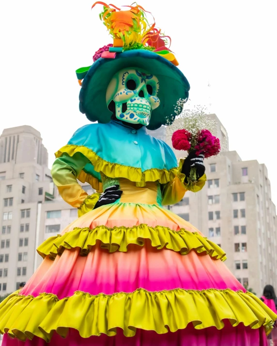 a large skeleton is sitting on top of a colorful dress