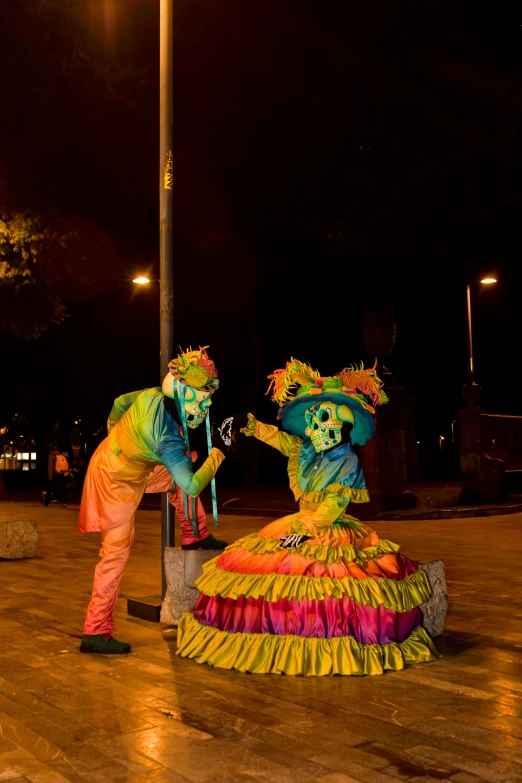 a couple of people are on stage wearing costumes