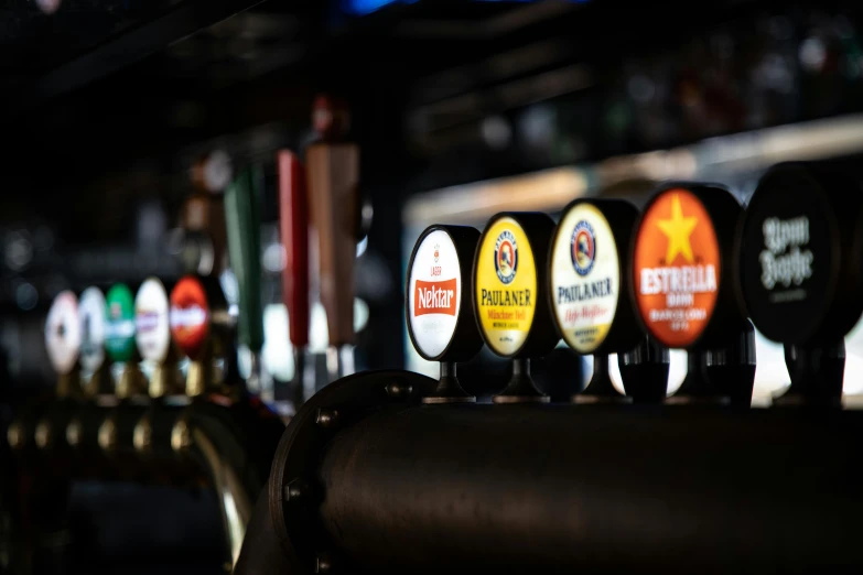 there are several beers lined up behind the bar