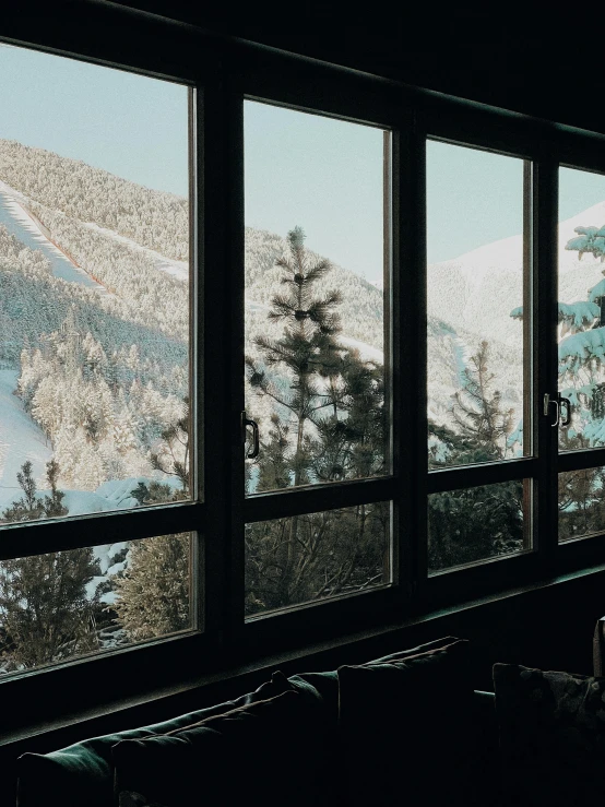 view from a large window looking out on the mountains