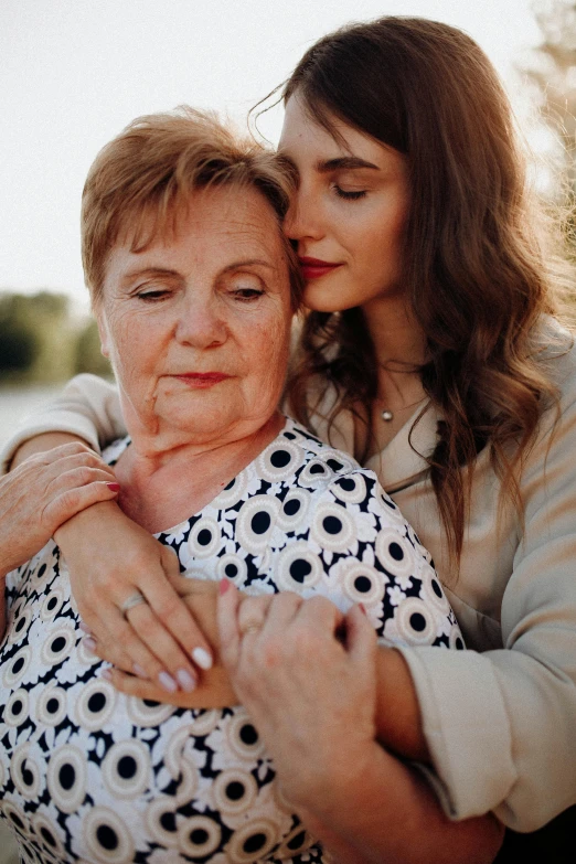 two women hugging each other on the beach