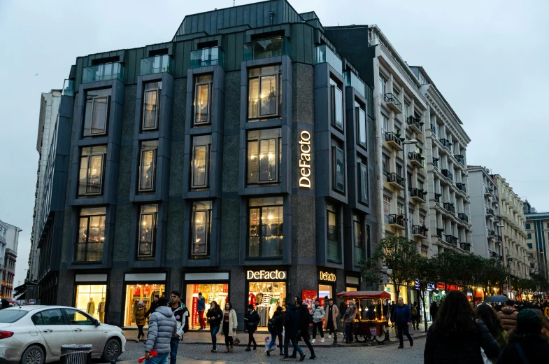 a building with people walking around it in the middle of a street