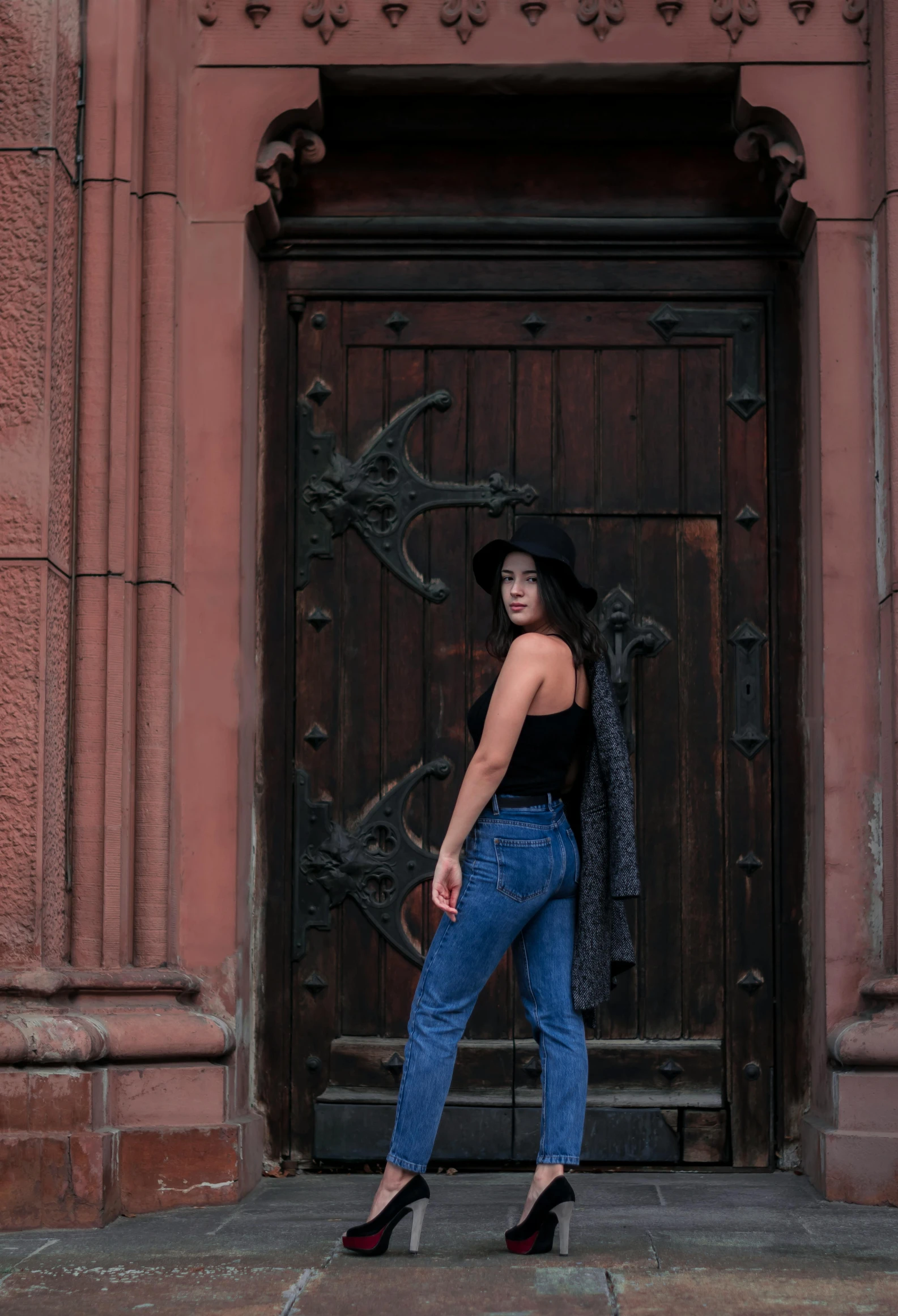 woman standing on the steps in front of a building