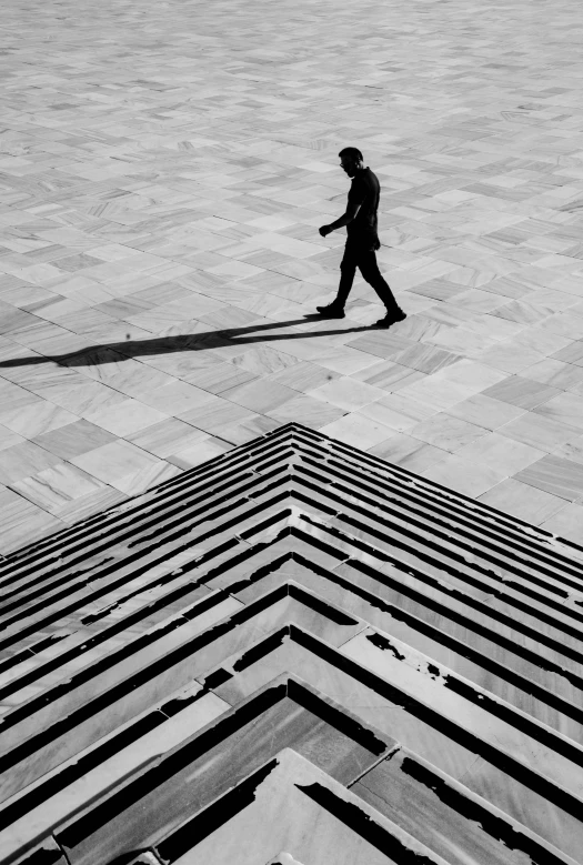 man walking down street in front of many lines