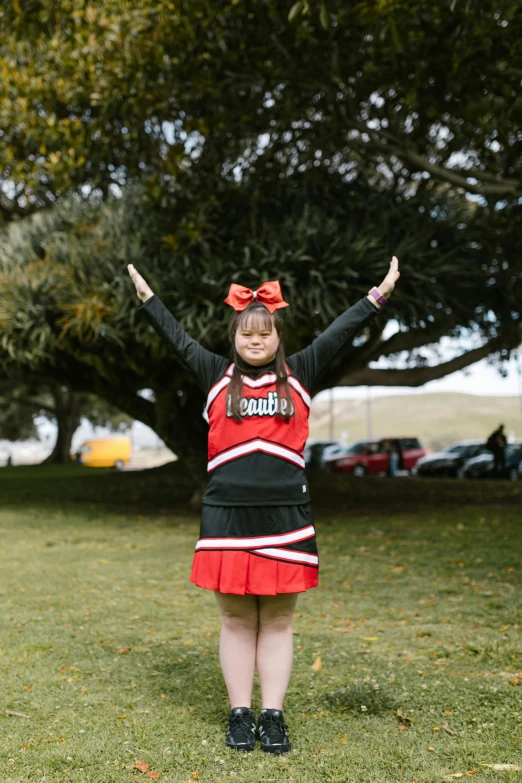 a woman in a cheerleader uniform posing for a picture