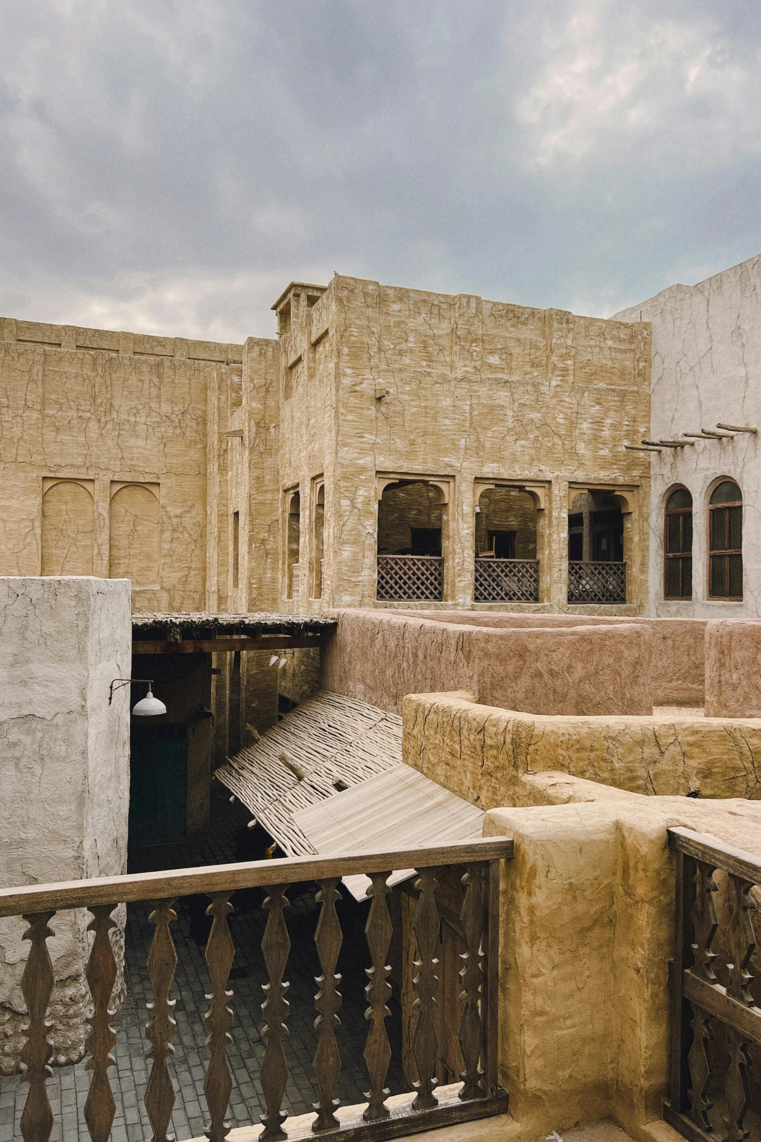 an alley way with concrete walls, and a white umbrella