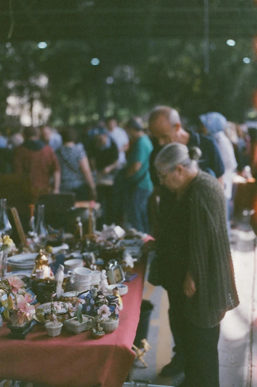 a group of people gathered around an outdoor market