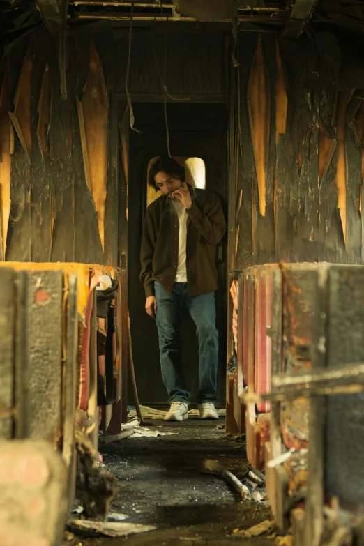 a man walking into an abandoned building with a dog