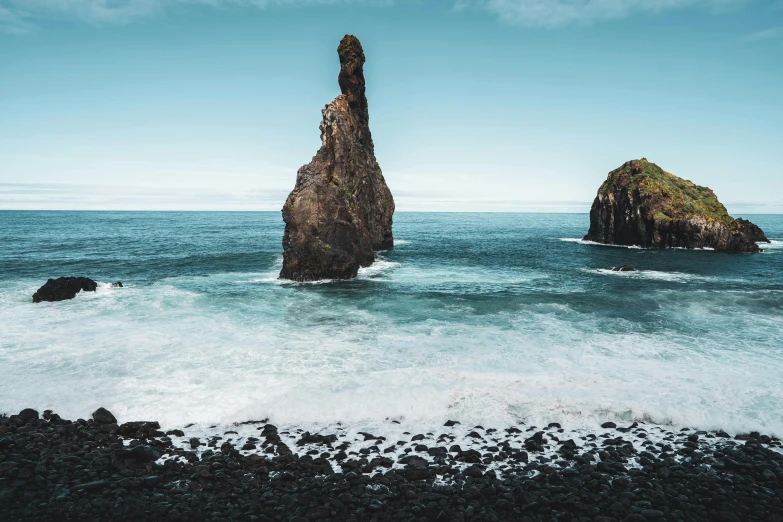 the rock that stands on top of the ocean in the middle of the water